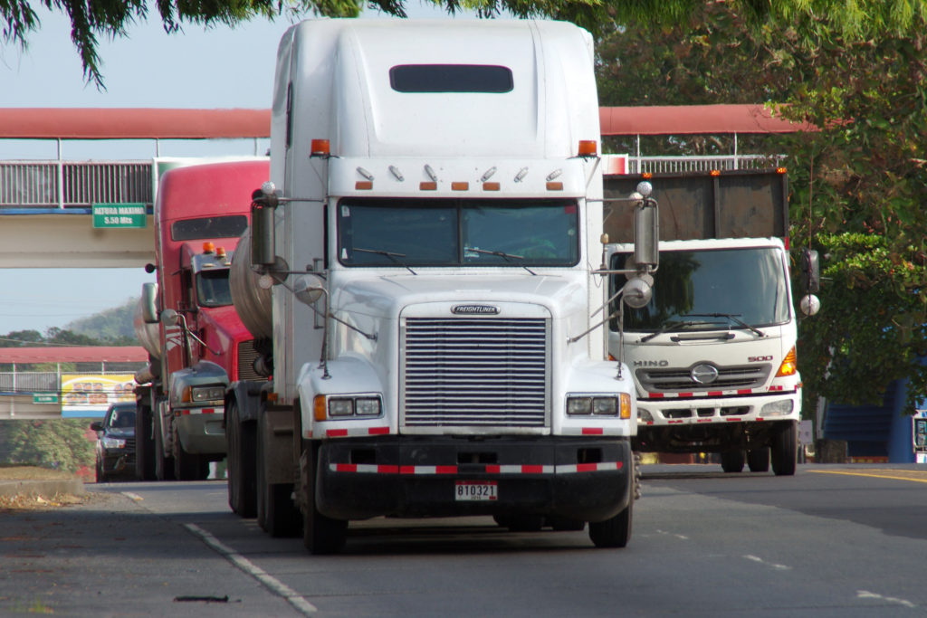 A professional driver performing safe semi-trailer moving outdoors